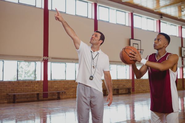 coach and player preparing to shoot foul shot