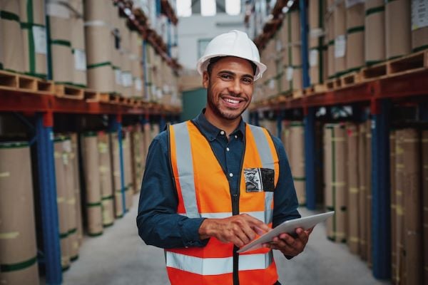 smiling male supply chain manager in warehouse