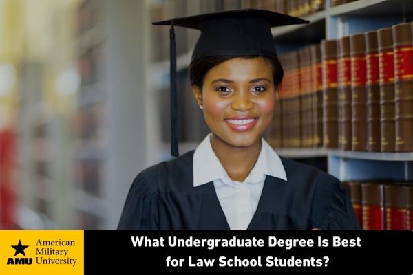 female graduate standing in front of bookshelf